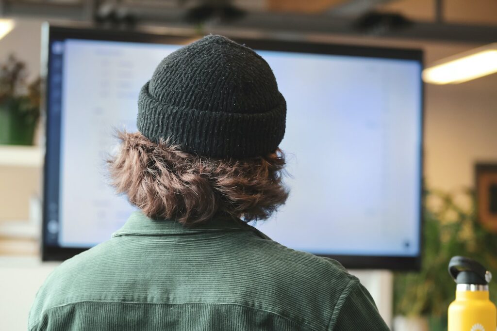 Man looking at large monitor